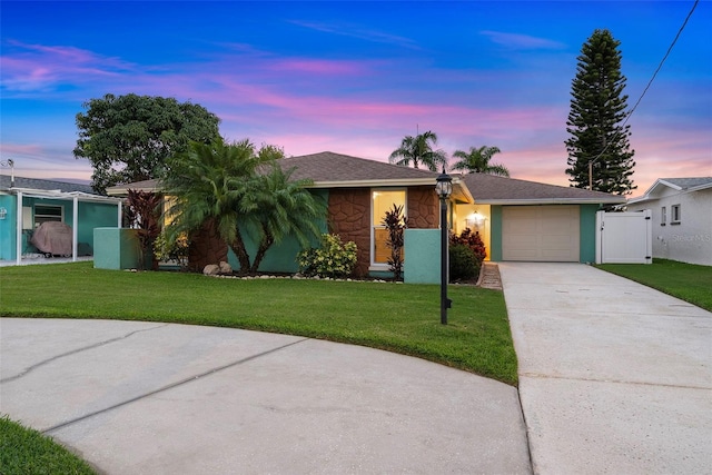 4252 Floramar Ter, New Port Richey, FL 34652 - single story home featuring concrete driveway, a garage, stone siding, a front lawn, and a gate