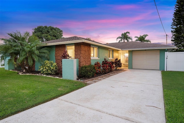 4252 Floramar Ter, New Port Richey, FL 34652 - single story home with an attached garage, concrete driveway, stone siding, and stucco siding