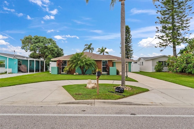 4252 Floramar Ter, New Port Richey, FL 34652 - ranch-style house with curved driveway and a front yard