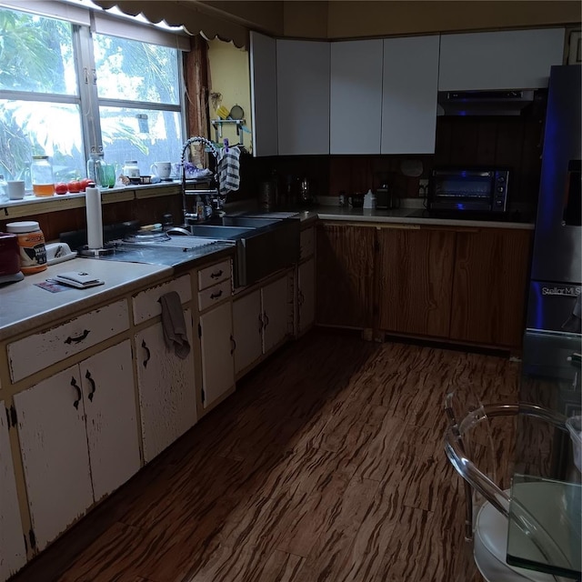 6615 New Tampa Hwy, Lakeland, FL 33815 - kitchen with white cabinets, extractor fan, and dark wood finished floors
