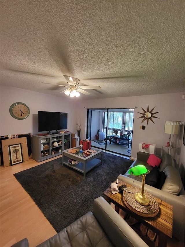 2685 Sabal Springs Cir Unit 202, Clearwater, FL 33761 - living room featuring a textured ceiling, a ceiling fan, and wood finished floors
