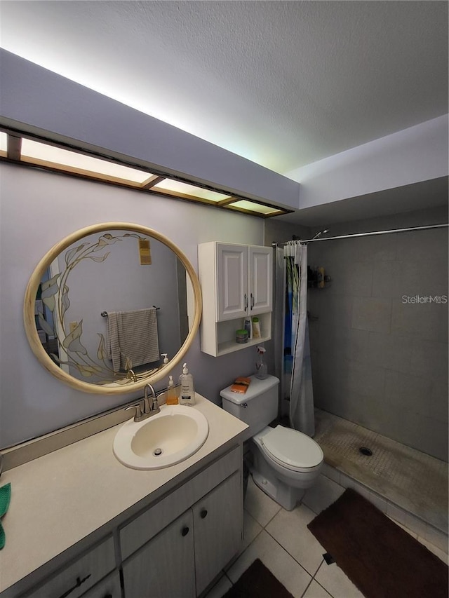 2685 Sabal Springs Cir Unit 202, Clearwater, FL 33761 - bathroom with tiled shower, vanity, tile patterned flooring, and a textured ceiling