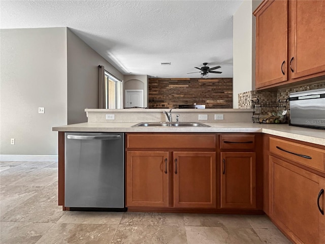 4079 Pacente Loop, Wesley Chapel, FL 33543 - kitchen with stainless steel dishwasher, a ceiling fan, brown cabinetry, light countertops, and a textured ceiling