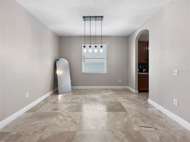 4079 Pacente Loop, Wesley Chapel, FL 33543 - empty room with arched walkways and baseboards