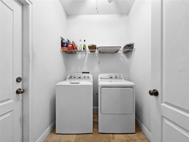 4079 Pacente Loop, Wesley Chapel, FL 33543 - laundry area featuring washing machine and clothes dryer and baseboards