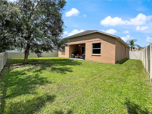 4079 Pacente Loop, Wesley Chapel, FL 33543 - rear view of property with stucco siding, a fenced backyard, and a patio