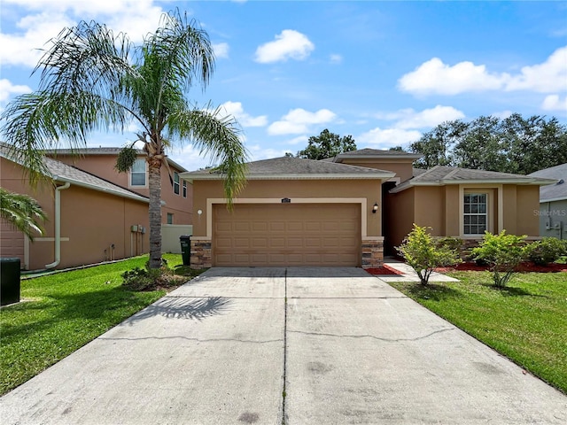 4079 Pacente Loop, Wesley Chapel, FL 33543 - view of front of property featuring stucco siding, concrete driveway, a garage, a front yard, and stone siding
