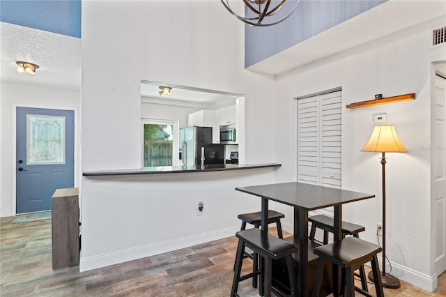 2095 Sunset Point Rd Unit 2201, Clearwater, FL 33765 - dining space featuring wood finished floors and a textured ceiling