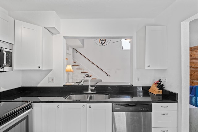 2095 Sunset Point Rd Unit 2201, Clearwater, FL 33765 - kitchen with appliances with stainless steel finishes, dark countertops, and white cabinets
