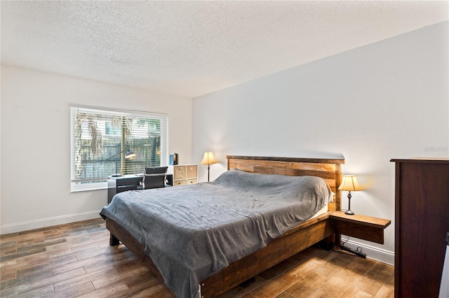2095 Sunset Point Rd Unit 2201, Clearwater, FL 33765 - bedroom with wood finished floors and a textured ceiling