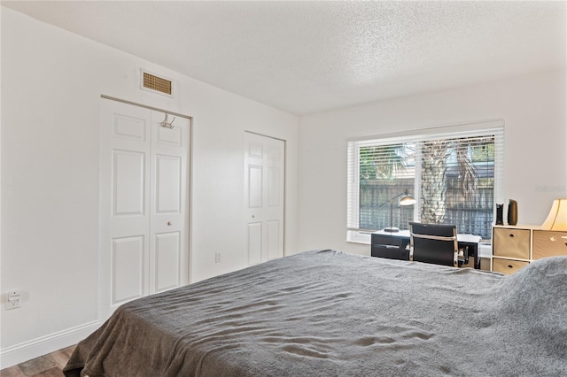 2095 Sunset Point Rd Unit 2201, Clearwater, FL 33765 - bedroom featuring wood finished floors and a textured ceiling