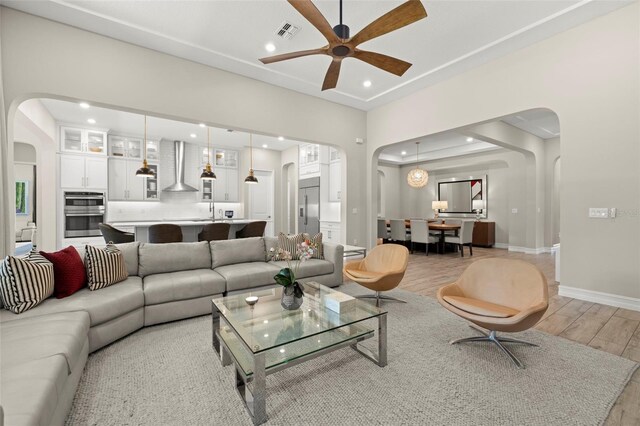 2839 Cordoba Ranch Blvd, Lutz, FL 33559 - living area with arched walkways, light wood-style flooring, recessed lighting, and a ceiling fan