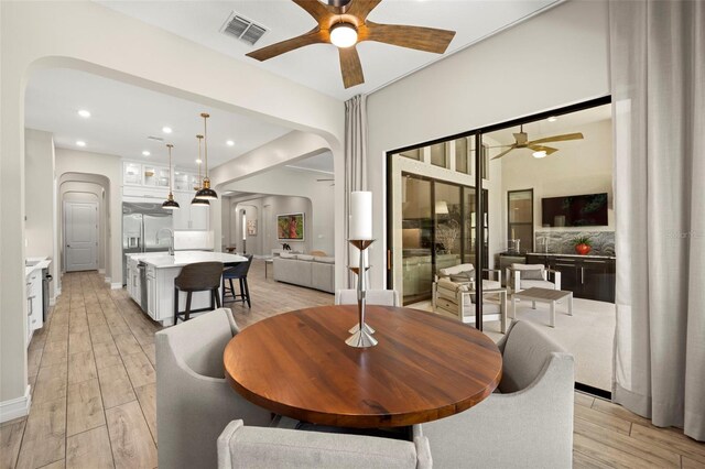 2839 Cordoba Ranch Blvd, Lutz, FL 33559 - dining room with ceiling fan, arched walkways, light wood finished floors, and recessed lighting