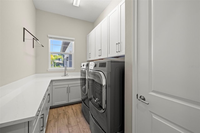 2839 Cordoba Ranch Blvd, Lutz, FL 33559 - laundry area featuring cabinet space, washing machine and clothes dryer, and light wood-style flooring