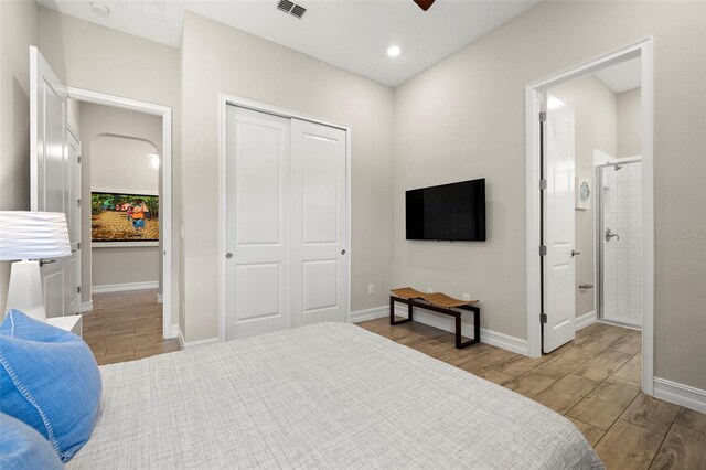2839 Cordoba Ranch Blvd, Lutz, FL 33559 - bedroom with wood finished floors, a closet, ensuite bathroom, and recessed lighting