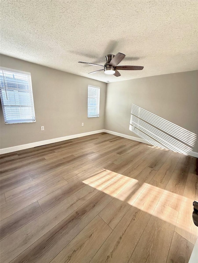 7314 Ivanhoe Dr, Port Richey, FL 34668 - empty room featuring a ceiling fan, wood finished floors, and a textured ceiling