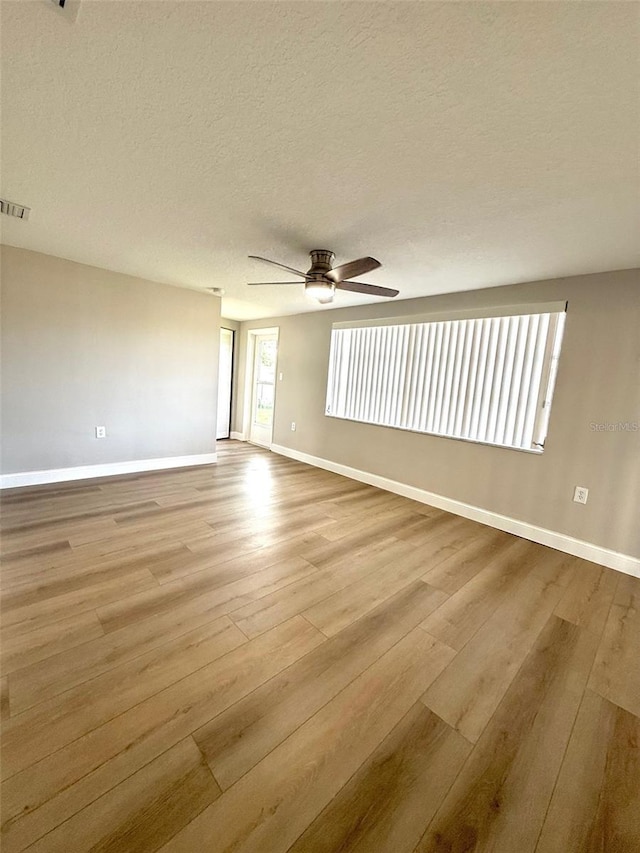 7314 Ivanhoe Dr, Port Richey, FL 34668 - empty room featuring wood finished floors, ceiling fan, and a textured ceiling