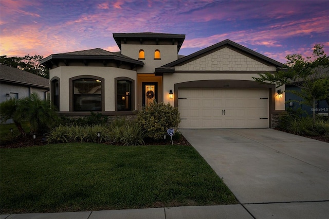 11597 Weaver Hollow Rd, New Port Richey, FL 34654 - mediterranean / spanish home with a garage, driveway, a yard, stucco siding, and stone siding