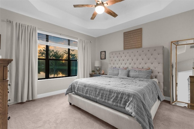 11597 Weaver Hollow Rd, New Port Richey, FL 34654 - bedroom featuring light carpet, a raised ceiling, and a ceiling fan