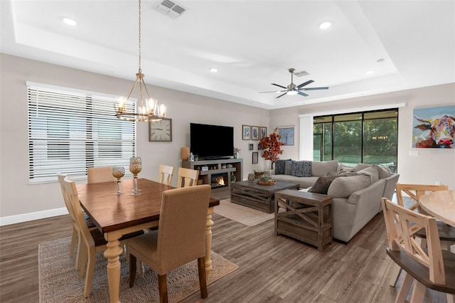 11597 Weaver Hollow Rd, New Port Richey, FL 34654 - dining area with a raised ceiling, wood finished floors, recessed lighting, a chandelier, and ceiling fan
