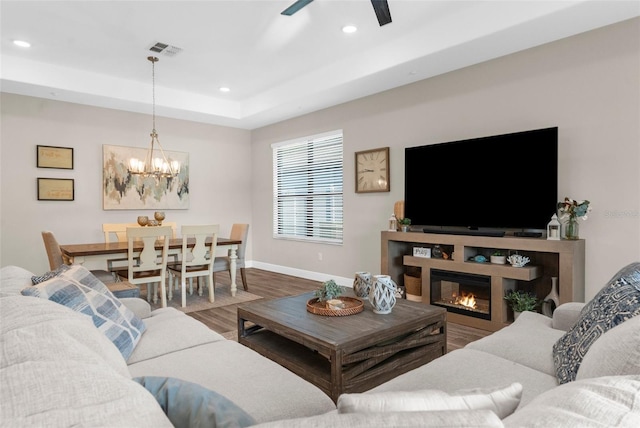 11597 Weaver Hollow Rd, New Port Richey, FL 34654 - living area with a chandelier, wood finished floors, recessed lighting, a ceiling fan, and a glass covered fireplace