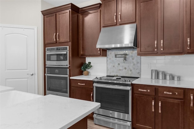 11597 Weaver Hollow Rd, New Port Richey, FL 34654 - kitchen with stainless steel appliances, exhaust hood, and tasteful backsplash