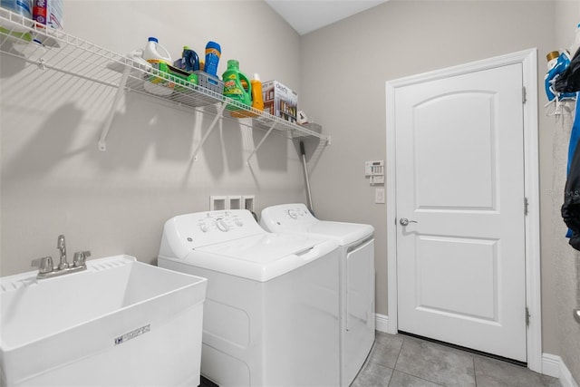 11597 Weaver Hollow Rd, New Port Richey, FL 34654 - laundry room with separate washer and dryer and light tile patterned flooring