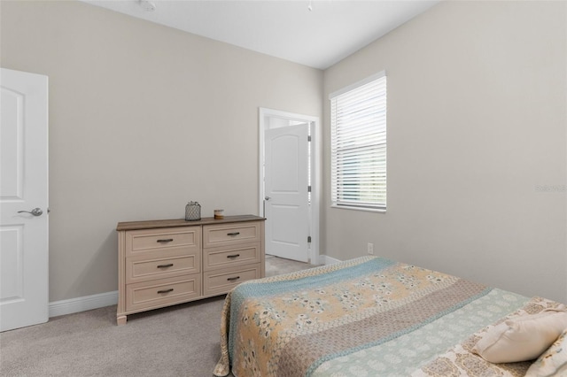 11597 Weaver Hollow Rd, New Port Richey, FL 34654 - bedroom featuring multiple windows and light colored carpet