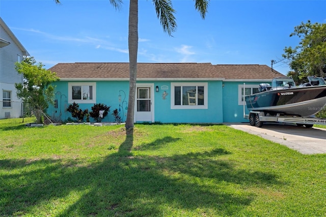3243 Azalea Dr, Hernando Beach, FL 34607 - ranch-style home with stucco siding, a front lawn, concrete driveway, and roof with shingles