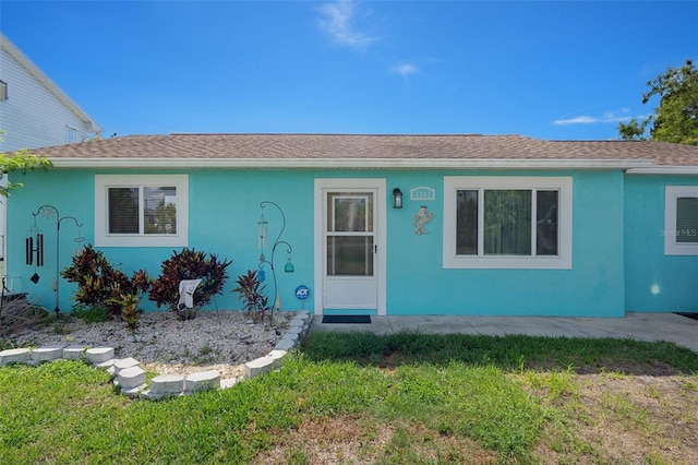 3243 Azalea Dr, Hernando Beach, FL 34607 - ranch-style home featuring a front lawn, a shingled roof, and stucco siding
