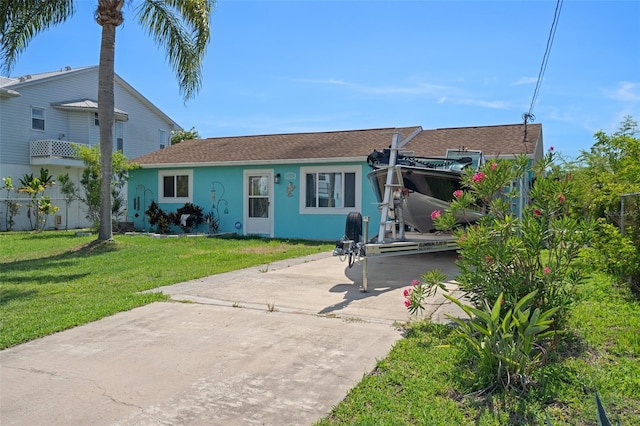 3243 Azalea Dr, Hernando Beach, FL 34607 - view of front of property featuring driveway, stucco siding, a front lawn, and roof with shingles