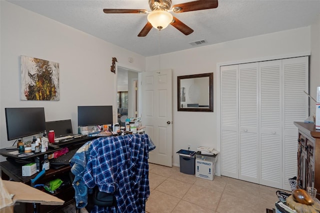 3243 Azalea Dr, Hernando Beach, FL 34607 - home office with ceiling fan, light tile patterned floors, and a textured ceiling