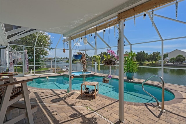 3243 Azalea Dr, Hernando Beach, FL 34607 - view of pool featuring a lanai, a patio area, a pool with connected hot tub, and a water view