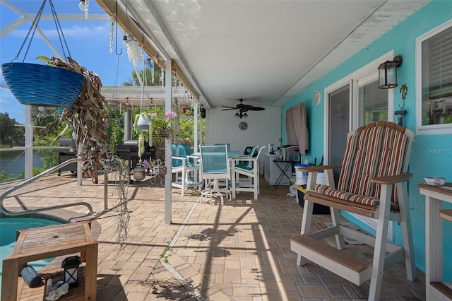 3243 Azalea Dr, Hernando Beach, FL 34607 - sunroom / solarium featuring a ceiling fan, outdoor dining area, and a water view