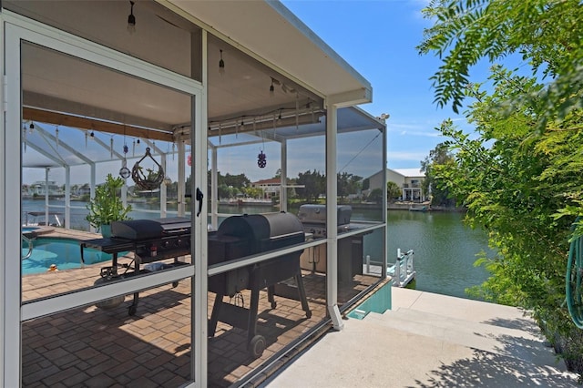 3243 Azalea Dr, Hernando Beach, FL 34607 - dock area with a water view, boat lift, glass enclosure, an outdoor pool, and a patio area