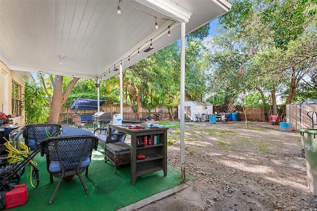 3622 W Mullen Ave, Tampa, FL 33609 - fenced backyard with a storage unit, a patio, and outdoor lounge area