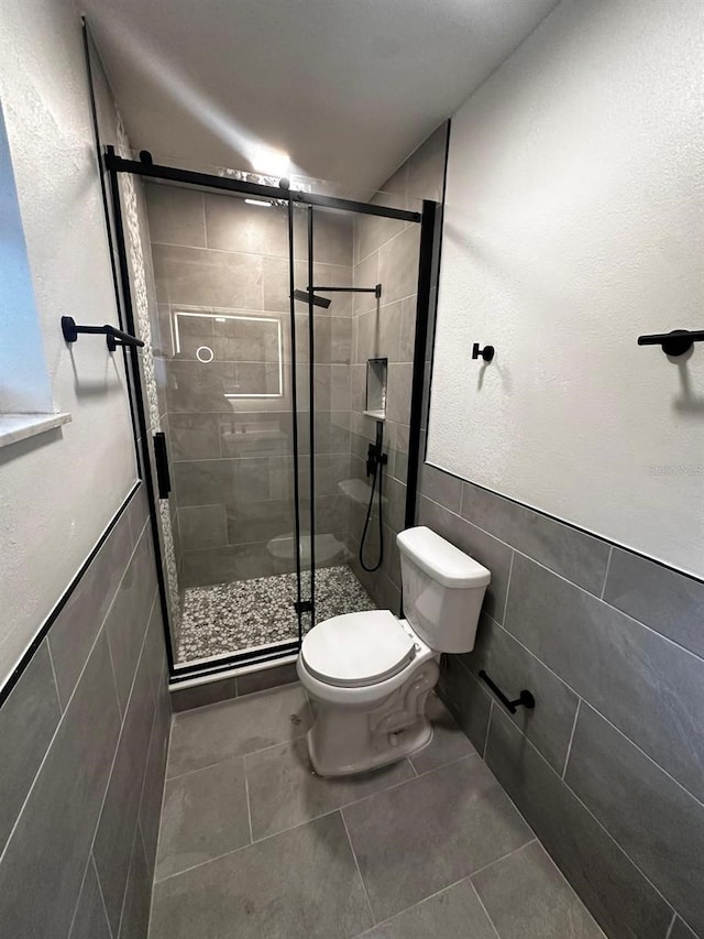 5950 Edison St, Cocoa, FL 32927 - bathroom with tile walls, a shower stall, and tile patterned floors