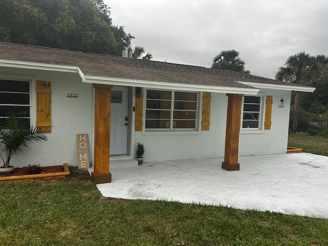 5950 Edison St, Cocoa, FL 32927 - view of front facade with stucco siding and a shingled roof