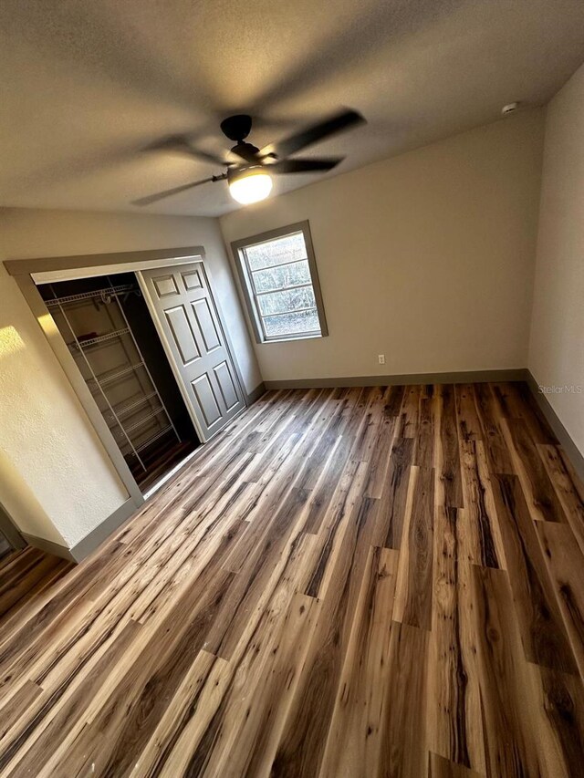 5950 Edison St, Cocoa, FL 32927 - unfurnished bedroom with dark wood-style floors, a ceiling fan, and a textured ceiling