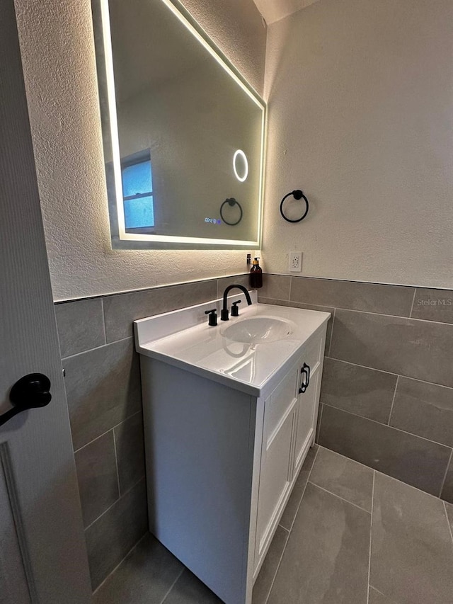5950 Edison St, Cocoa, FL 32927 - bathroom featuring tile walls, vanity, tile patterned floors, and a textured wall