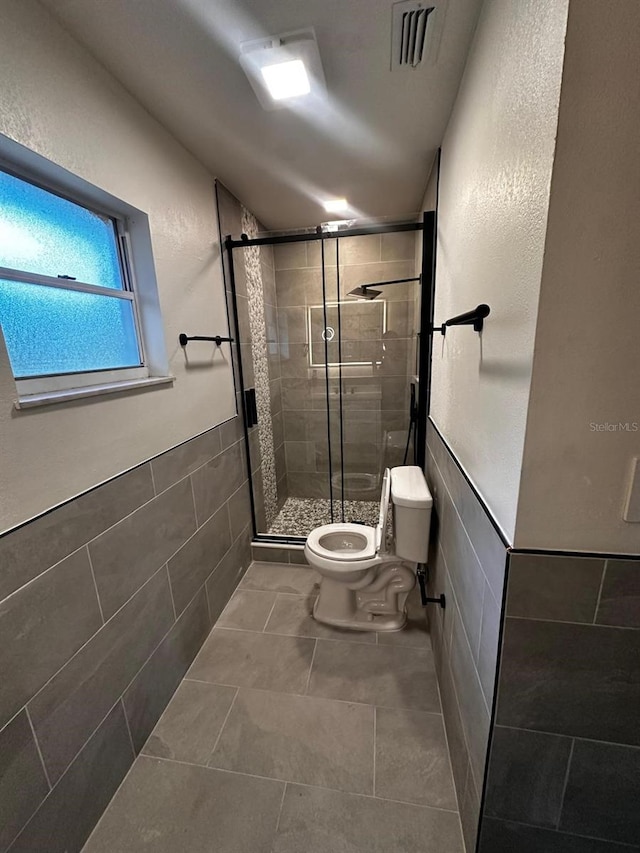 5950 Edison St, Cocoa, FL 32927 - bathroom with tile walls, a stall shower, and tile patterned floors