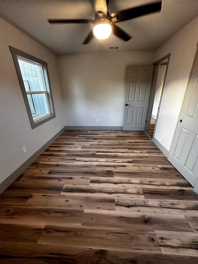 5950 Edison St, Cocoa, FL 32927 - unfurnished bedroom featuring dark wood-style flooring and ceiling fan
