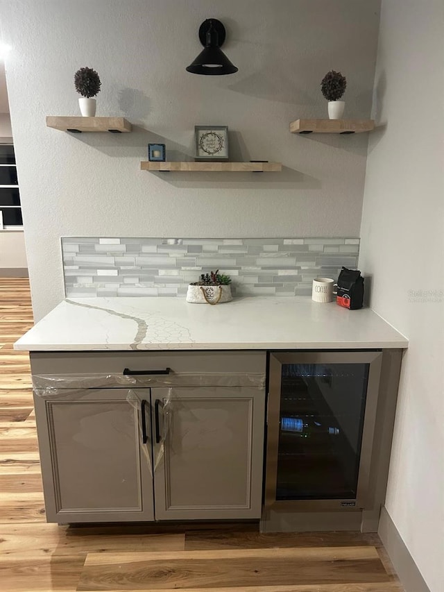 5950 Edison St, Cocoa, FL 32927 - bar with beverage cooler, tasteful backsplash, and light wood-style floors