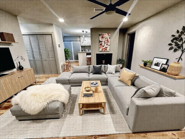 5950 Edison St, Cocoa, FL 32927 - living area featuring wood finished floors, ceiling fan, and recessed lighting