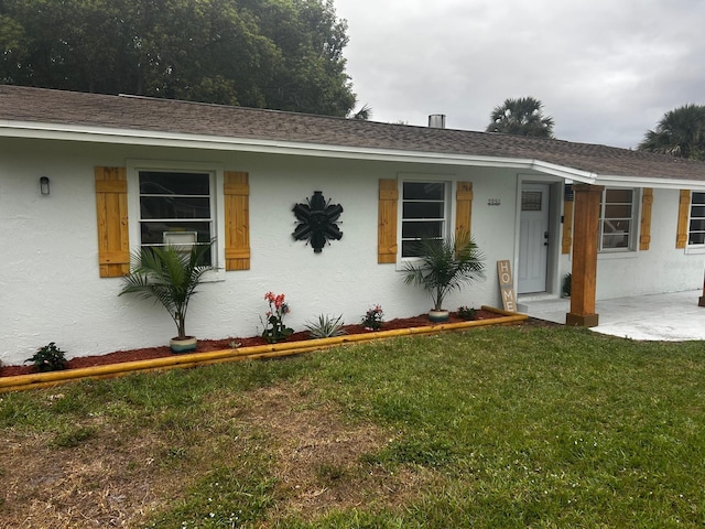 5950 Edison St, Cocoa, FL 32927 - ranch-style home with stucco siding and a front lawn