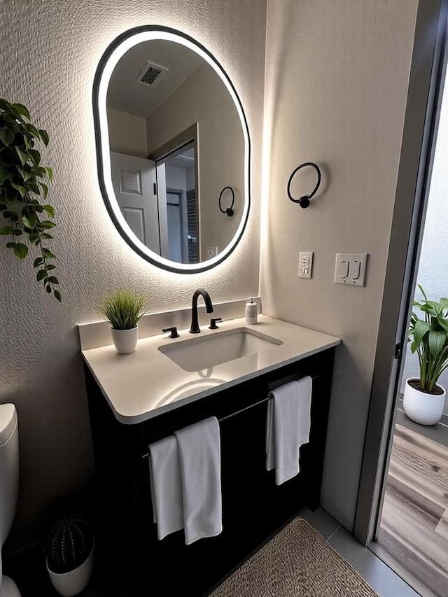 5950 Edison St, Cocoa, FL 32927 - bathroom featuring vanity, tile patterned floors, and a textured wall
