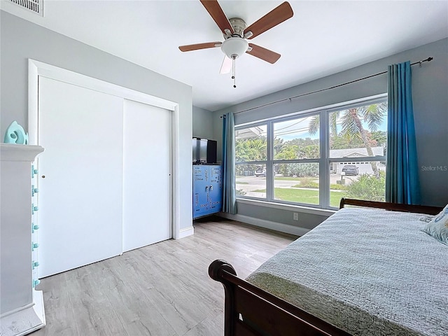 1445 Coburn Dr, Tarpon Springs, FL 34689 - bedroom with wood finished floors, a closet, and a ceiling fan