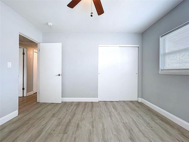 1445 Coburn Dr, Tarpon Springs, FL 34689 - unfurnished bedroom with wood finished floors, a ceiling fan, and a closet