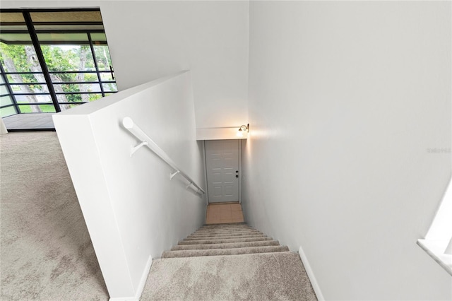 5785 Gardens Dr, Sarasota, FL 34243 - staircase featuring carpet