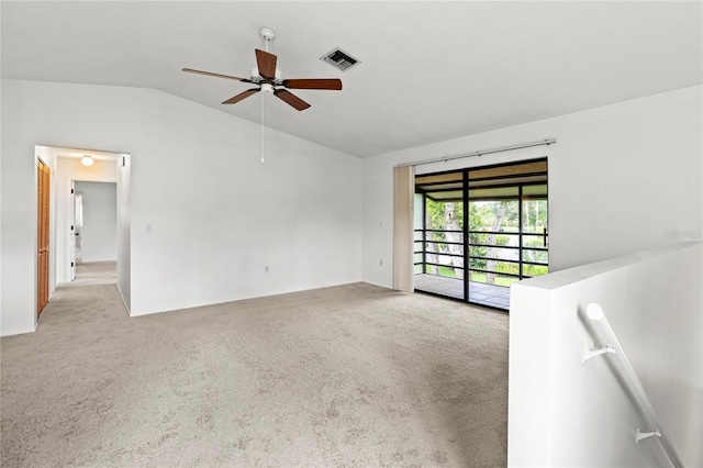 5785 Gardens Dr, Sarasota, FL 34243 - spare room with lofted ceiling, carpet floors, and a ceiling fan